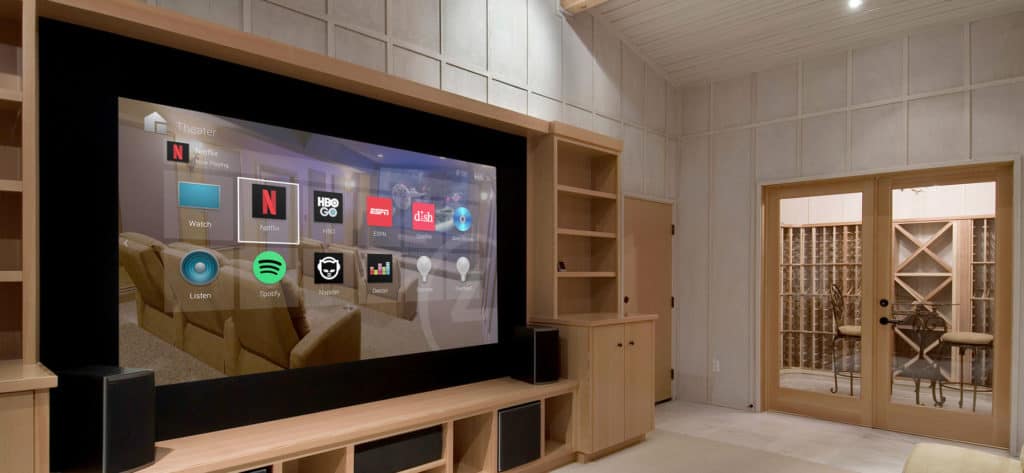 A home theater with a tv mounted on the wall.