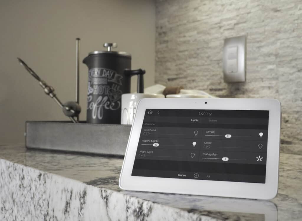 A tablet sits on a kitchen counter, allowing for easy control of lighting design.