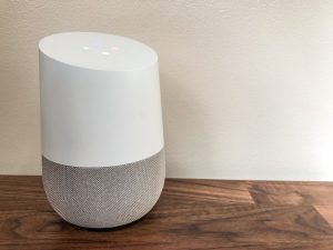 Google Home smart speaker on a wooden sideboard