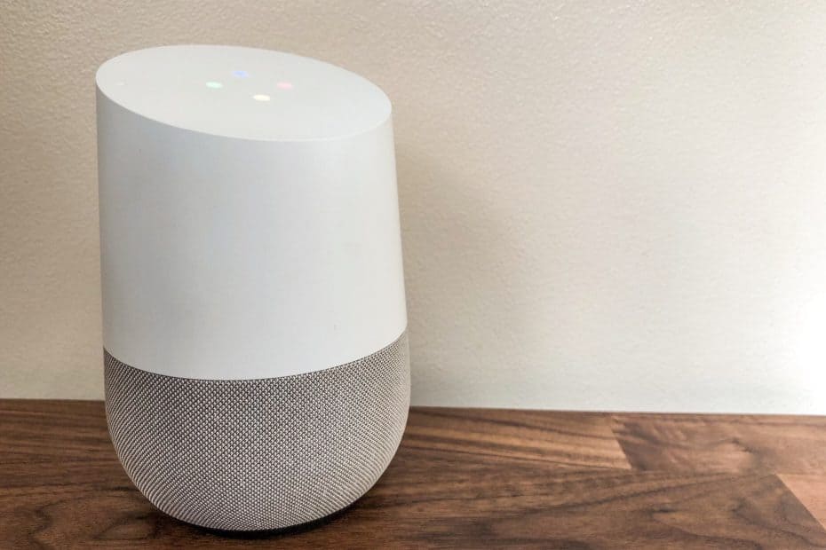 Google Home smart speaker on a wooden sideboard