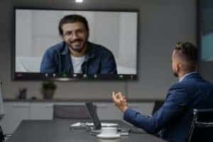 Middle eastern businessman having video chat with employee at office