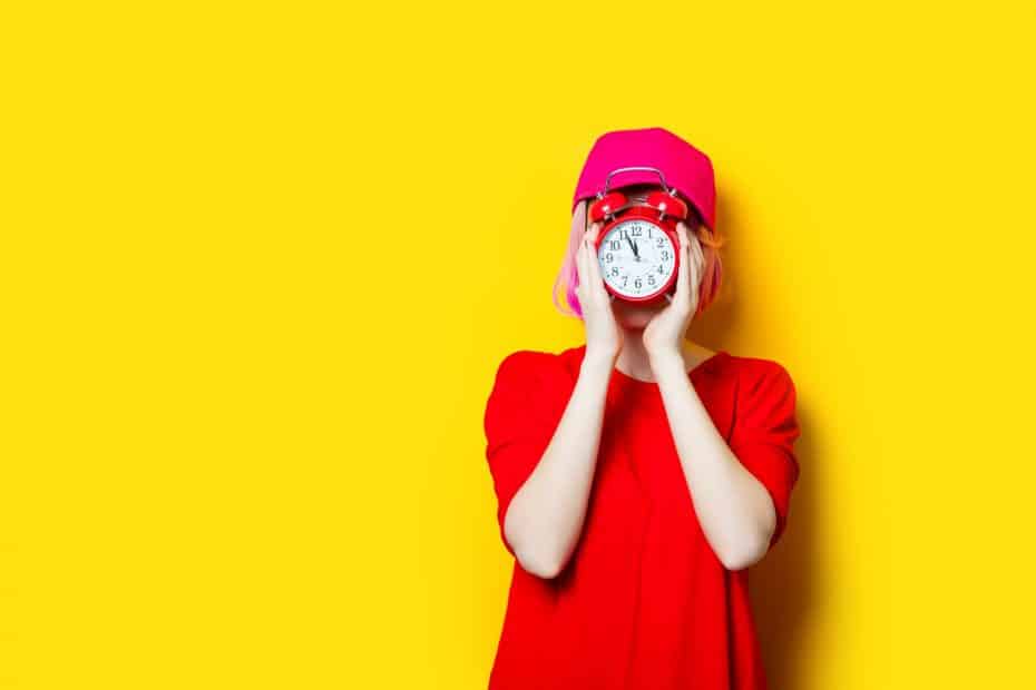 young woman with alarm clock